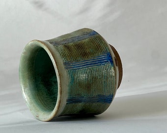 Textured blue-green wheel thrown stoneware ceramic tea and coffee cup.
