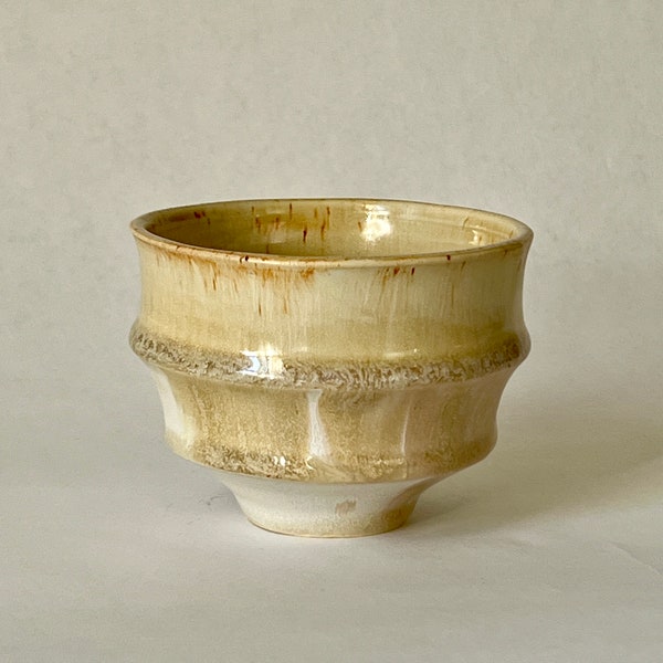 Creamy beige and matte white wheel thrown stoneware ceramic cup.