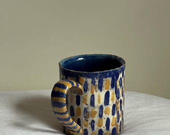 Blue and yellow handmade stoneware ceramic mug.