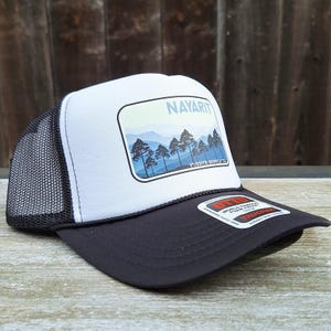 May include: White and black trucker hat with a blue and green mountain scene and the text "Nayarit" and "Fuente Supply Co."