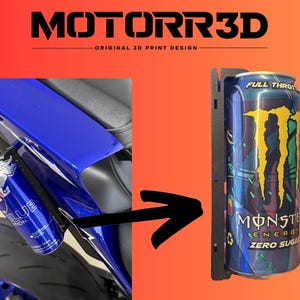 May include: Black 3D-printed motorcycle can holder with a Monster Energy Zero Sugar can. The holder is mounted on a blue motorcycle. The text "MOTORR3D ORIGINAL 3D PRINT DESIGN" is at the top.