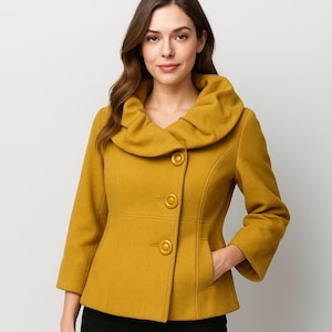 May include: A white ceramic mug with a black handle and the text "But First, Coffee" in a bold, black font. The mug is set against a neutral background, highlighting its simple design.