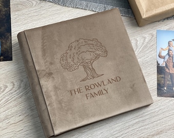 May include: A brown faux leather photo album with a tree design and the text "The Rowland Family" embossed on the front.
