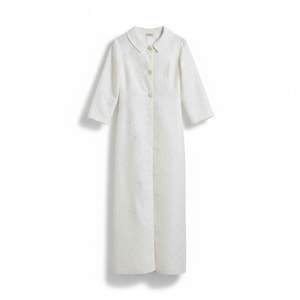 May include: A long, white, button-down coat with three-quarter sleeves. The coat has a collared neckline and a textured pattern throughout the fabric. The coat is floor-length and has a tailored fit.