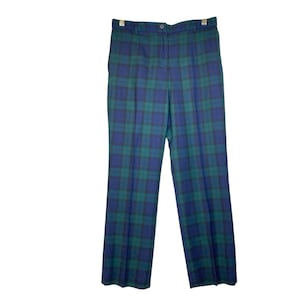 May include: Blue and green plaid pants. The pants have a button and zipper closure, belt loops, and a classic straight-leg fit. The plaid pattern features a combination of dark blue, green, and black lines.