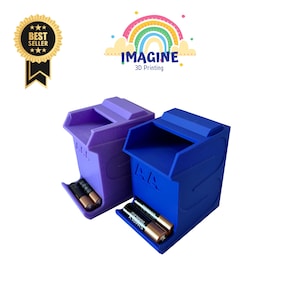 May include: Two 3D-printed battery organisers, one purple and one blue, each holding AA batteries. The organisers have a unique design with a sloped front for easy access. The image includes the text "IMAGINE 3D Printing" and a "Best Seller" badge.