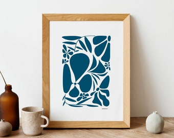 May include: A framed print with a blue abstract floral design. The print is in a light wood frame and is sitting on a wooden table.