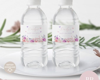 May include: Two clear plastic water bottles with labels featuring a watercolor floral design in shades of pink, purple, and blue. The labels also include the text "Emily's Baby Shower" and butterflies.