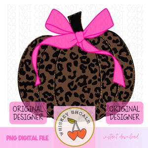 May include: A digital design of a pumpkin with a leopard print pattern and a bright pink bow. The pumpkin has a black stem and gold trim. The design includes the text "Original Designer" and "Whiskey Shoals".