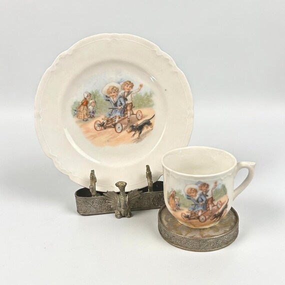 Antique Victorian “Children On a Scooter Germany ” Cup and Matching Plate (2). 1900’s. Germany. Mint.