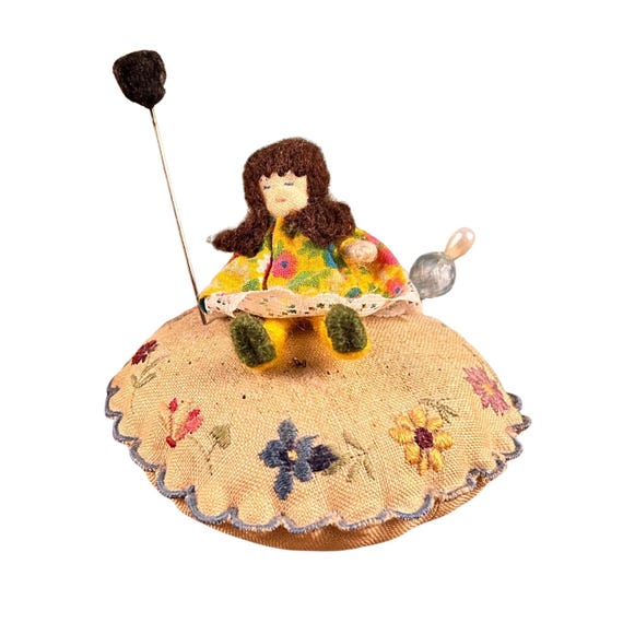 Vintage floral pin cushion with removable handmade doll and two decorative pins/hat pins