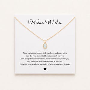 May include: A gold chain necklace with an oval opal pendant displayed on a white card featuring the text October Wishes and a message about birthstones, ending with a small black heart icon at the bottom center of the card.