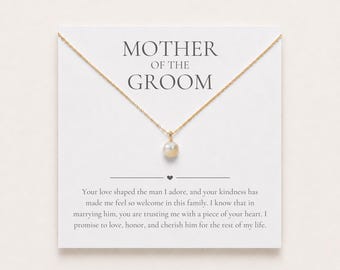 May include: A gold chain necklace with a single white pearl pendant displayed on a white card. The card features the text MOTHER OF THE GROOM and a printed message: Your love shaped the man I adore, and your kindness has made me feel so welcome in this family. I know that in marrying him, you are trusting me with a piece of your heart. I promise to love, honor, and cherish him for the rest of my life.