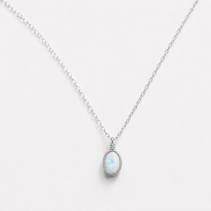 May include: A silver-toned necklace featuring a delicate chain and a single oval-shaped pendant. The pendant contains a smooth, iridescent white stone with subtle blue and pink flashes, secured by a simple wire-wrapped metal setting at the top.