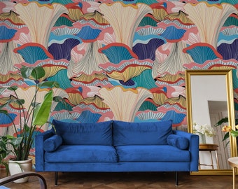 May include: A living room with a blue velvet sofa, a white rug, and a gold-framed mirror. The focal point is a wall covered in colorful, abstract floral wallpaper in shades of pink, blue, and yellow. Potted plants add a touch of nature.