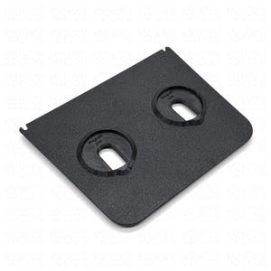 May include: A black, textured rectangular plate with two circular cutouts. Each cutout has a semi-circular opening. The text "Registo 23W" is printed within each circle. The plate has a small notch on one side.