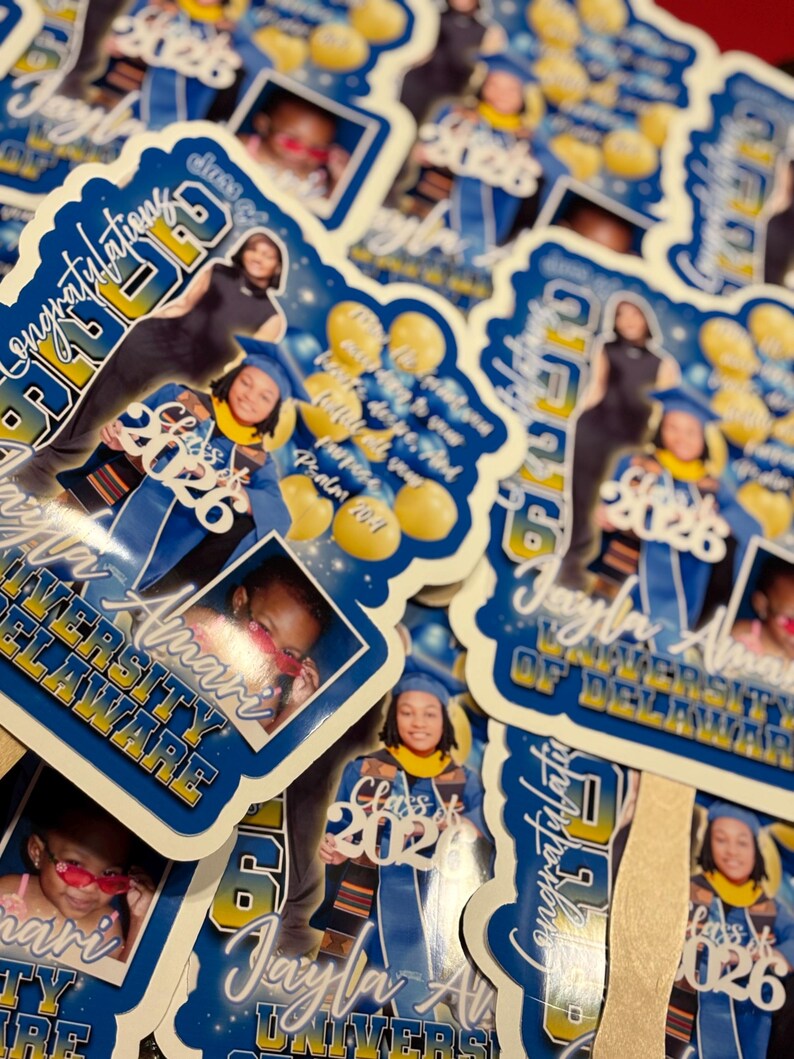 May include: A collection of graduation stickers featuring a graduate in a cap and gown. The stickers are blue and white with the text "Congratulations Class of 2026" and the graduate's name and university. There are also photos of the graduate.