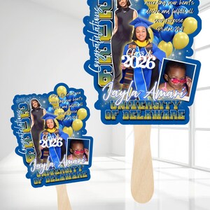 May include: Two graduation fan favors with wooden handles. The fans feature a blue and gold design with photos, text that reads "Congratulations Class of 2026", and the name "Jayla Amari" and "University of Delaware".