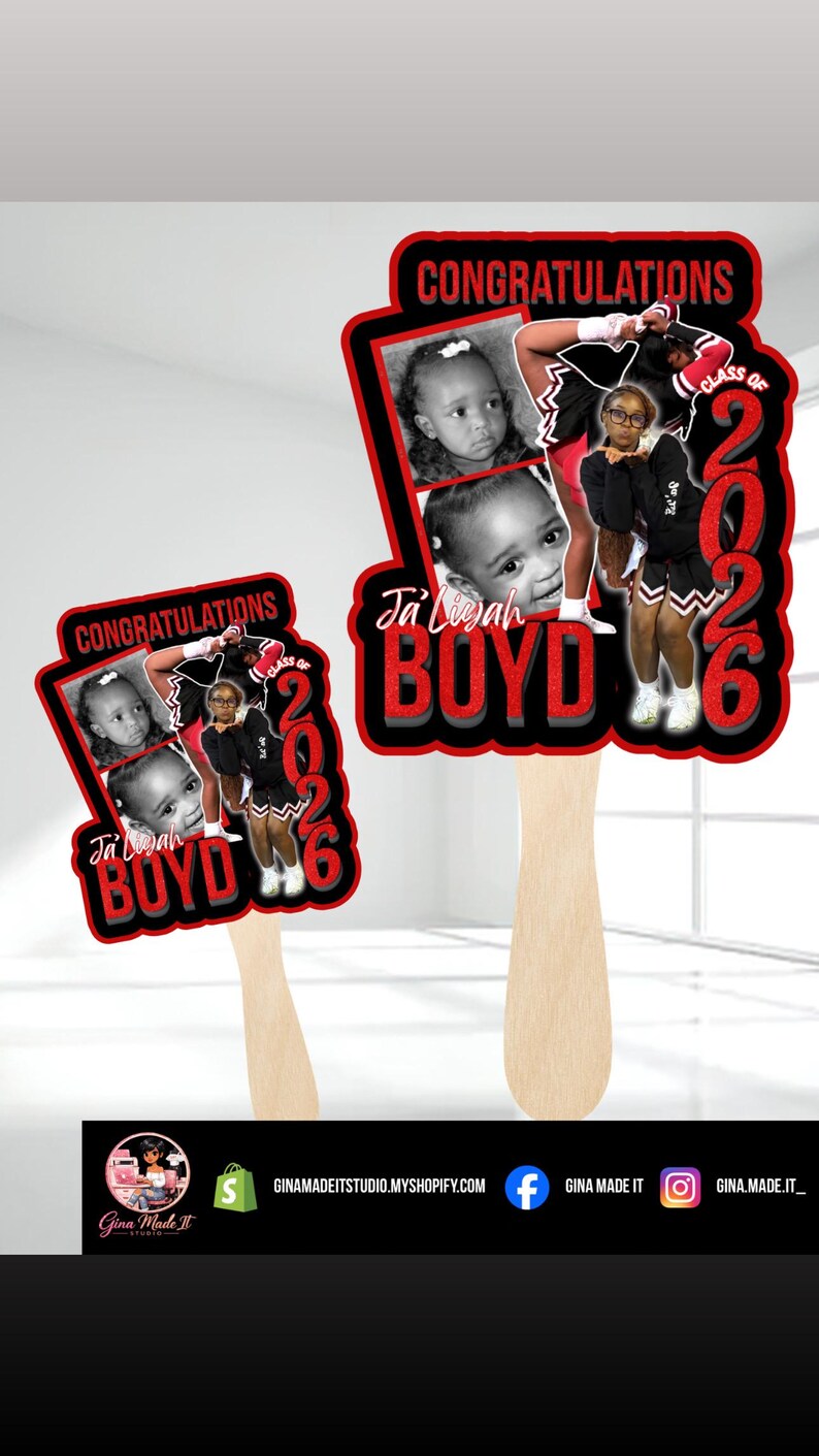 May include: Two graduation fan decorations. Each fan features a photo of a child, the name "Ja'Liyah Boyd", and the text "Congratulations" and "Class of 2026" in red and black. The fans have wooden handles.