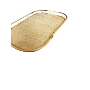 May include: An oval-shaped serving tray constructed from light tan woven bamboo strips. The tray features a raised, curved bamboo frame border that encircles the flat, intricately woven base, showcasing a natural light brown wood grain texture.