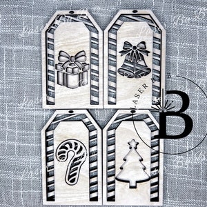 May include: Four wooden Christmas gift tags with a candy cane, a Christmas tree, a present with a bow, and a pair of bells. Each tag has a red and white striped background.