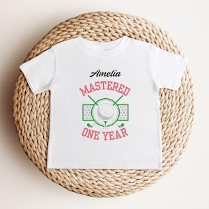 T-shirt d&#39;anniversaire d&#39;un an personnalisé pour maîtrise du golf | T-shirt rose pour fille pour le 1er anniversaire sur le thème du golf | Fête du premier anniversaire Trou d&#39;un coup