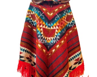 May include: A hooded poncho with a vibrant geometric pattern in red, blue, yellow, and white. The poncho features a fringed hem and a hood with a matching design. The word "Kintu" is visible on the lower right.