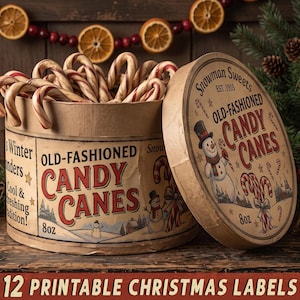 May include: A round cardboard container filled with red and white striped candy canes. The label features a snowman illustration, the text Snowman Sweets, Old-Fashioned Candy Canes, 8oz, and Winter Wonders. The lid is leaning against the container.