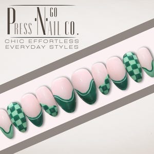 May include: Green and white checkered nail tips with a green and white wavy design on some of the tips. The tips are arranged in a row on a white surface. The text "Press Nail Co." is visible in the top left corner of the image.