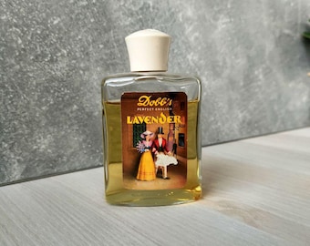 May include: A vintage perfume bottle with a white cap and a label featuring the text "Dobb's PERFECT ENGLISH LAVENDER". The label depicts a couple in period clothing. The bottle contains a yellow liquid.