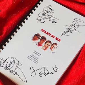 May include: A white booklet with the title "Stand By Me" and the names of the director, writer, and producers. The booklet is signed by four people, including Rob Reiner, Stephen King, and the actors Wil Wheaton and Jerry O'Connell.