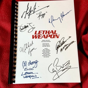 May include: A white script with the title "Lethal Weapon" and the names of the director, writer, and cast members. The script is signed by Mel Gibson, Danny Glover, Gary Busey, and other cast members.