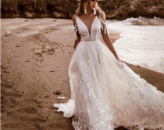 Raina | Bohemian Wedding Dress with Plunge Neckline and Off-the-Shoulder Tassels | Elegance and Bohemian Flair.