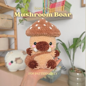 May include: A plush crochet toy shaped like a boar with a brown mushroom cap featuring white spots. The creature has a tan body, dark brown snout, hooves, and tusks. Text on the image reads low sew Mushroom Boar and PDF PATTERN ONLY.