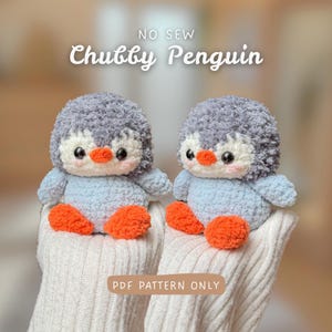 May include: Two handmade, plush penguin toys. The penguins have gray heads, light blue bodies, orange feet, and black eyes. The text "NO SEW Chubby Penguin" and "PDF PATTERN ONLY" are displayed on the image.
