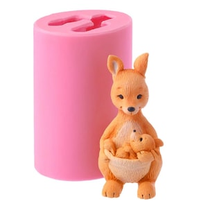 May include: Pink silicone mould for making a cake topper of a kangaroo holding a joey in its pouch. The mould is cylindrical and has a smooth surface.