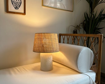 Table lamp with carved minimal pattern and straw lampshade