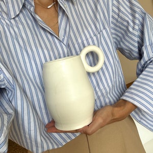 White minimal vase with a round handle image 2