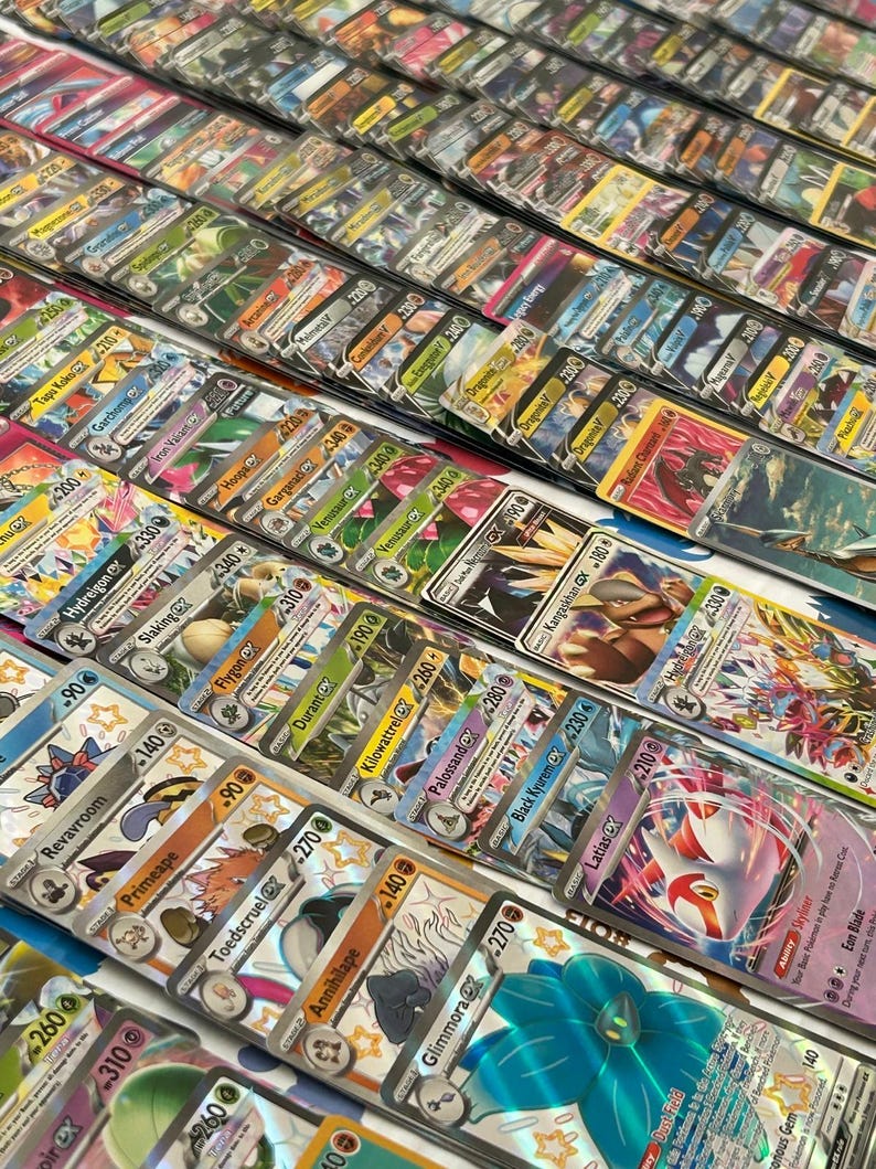 May include: A selection of vibrant trading cards, displaying diverse characters and designs. The cards are organised in rows, highlighting a range of artwork and text. The cards seem to be in protective sleeves, focusing on collectible card games.
