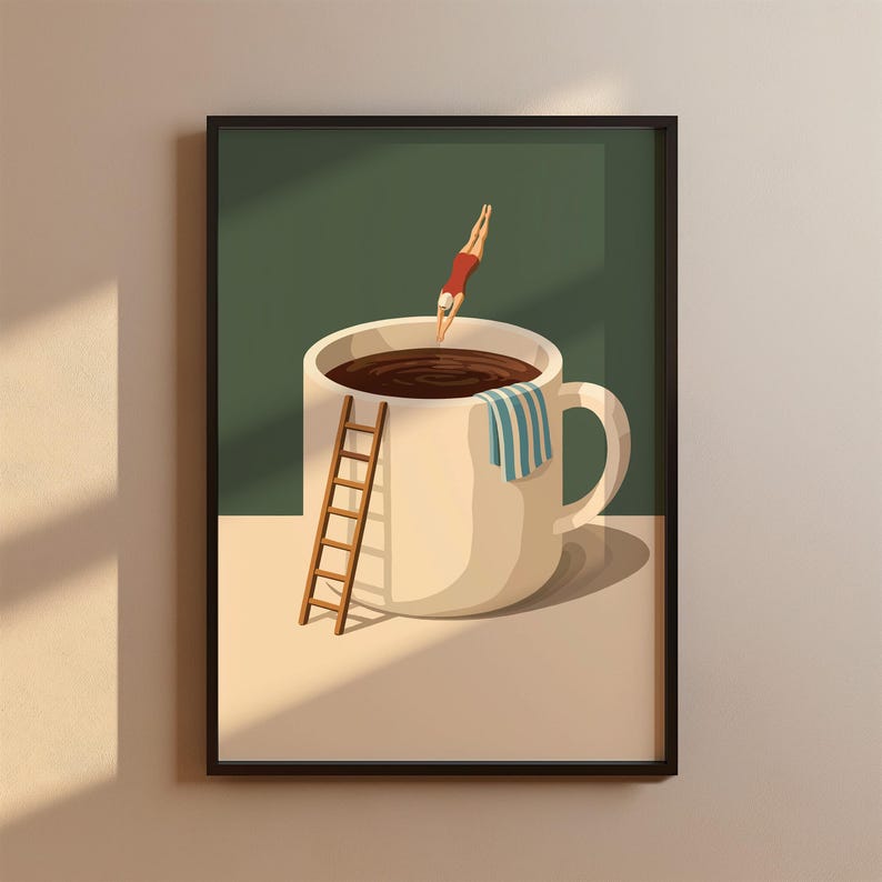 May include: A framed art print depicts a whimsical scene of a person diving into a coffee-filled mug. A small wooden ladder leans against the mug, and a striped towel hangs on the handle. The diver wears a red swimsuit. The background is a two-tone green and beige.