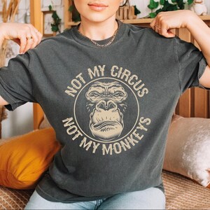 a woman wearing a t - shirt that says not my circus, not my money