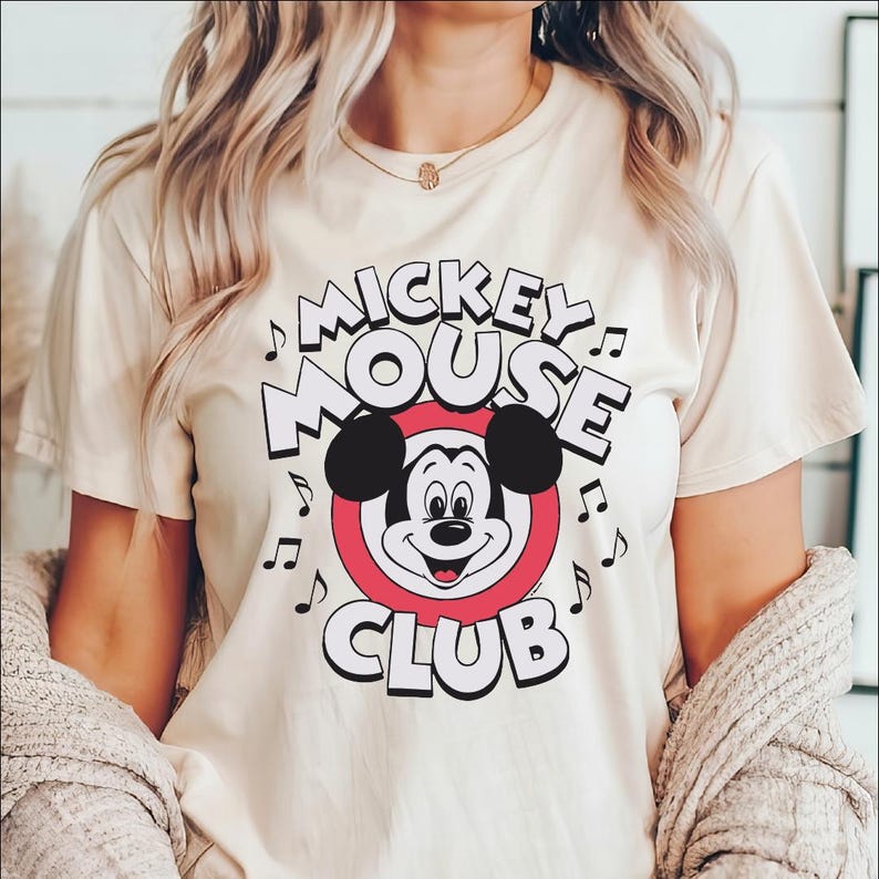 a woman wearing a mickey mouse club t - shirt