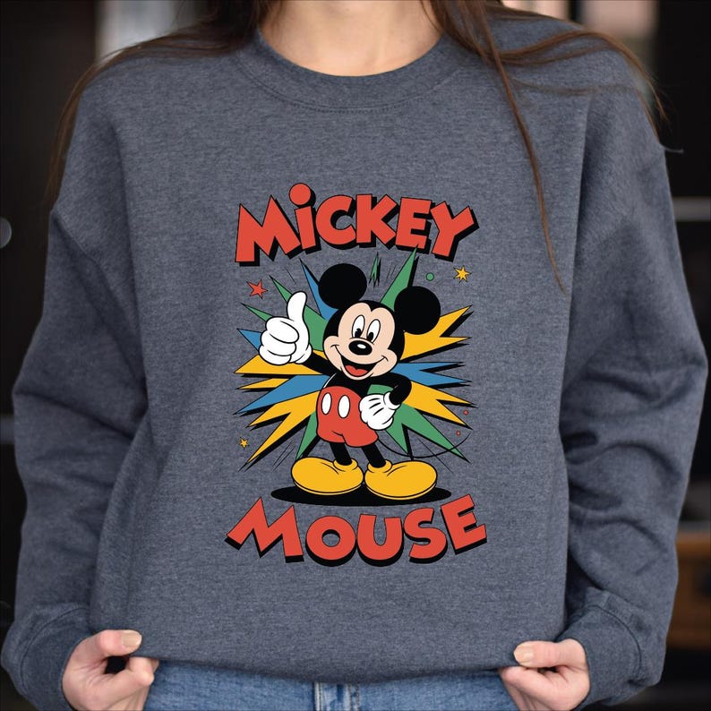 A gray sweatshirt with a colorful graphic of Mickey Mouse and the text "MICKEY MOUSE" printed on it.