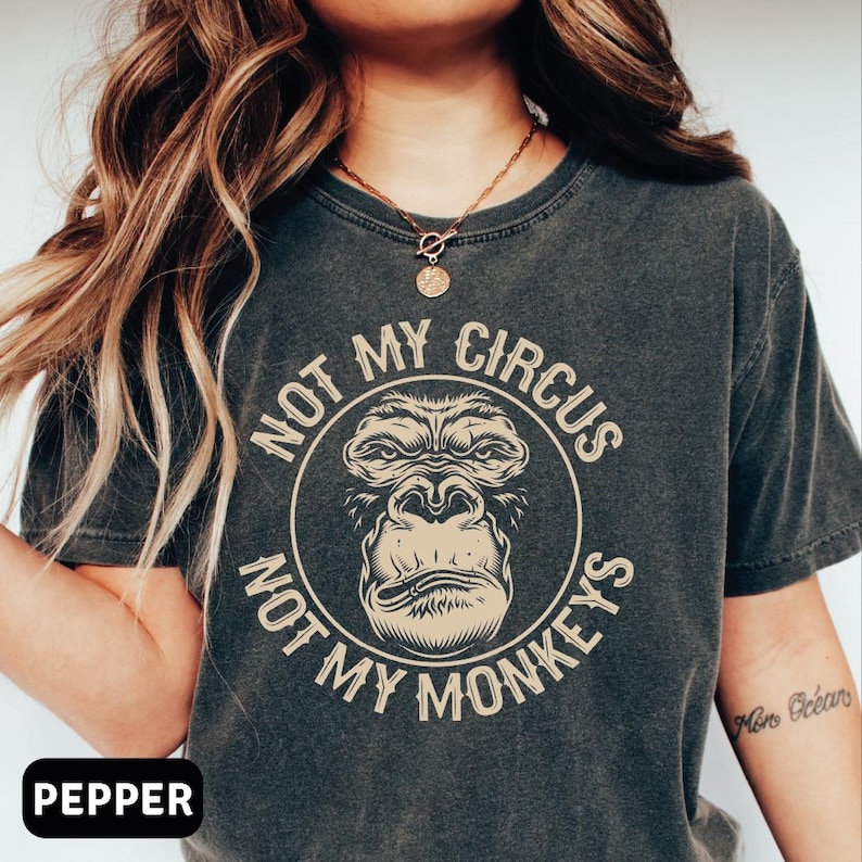a woman wearing a black shirt with a monkey on it