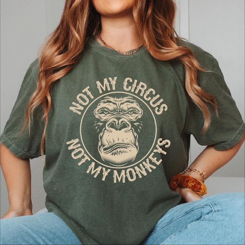 a woman wearing a t - shirt that says not my circus, not my monkeys