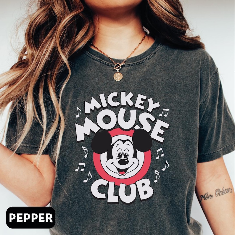 a woman wearing a mickey mouse club shirt