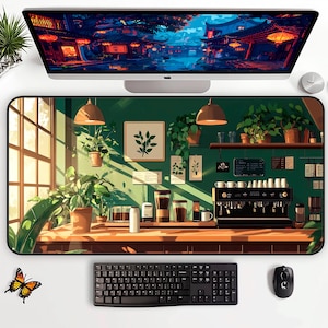 May include: A large desk mat featuring a coffee shop scene with a black espresso machine, plants, and a wooden counter. A computer monitor displays a digital art scene. A black keyboard and mouse are in the foreground.