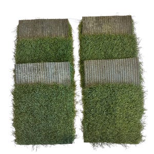 May include: Two sets of artificial moss squares, each with a textured, gray-brown top layer and a vibrant green, textured moss base. The squares are arranged side-by-side against a white background, showcasing their contrasting textures and colors.