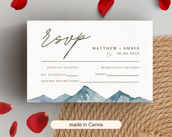 May include: Cream-colored RSVP card with elegant script and mountain watercolor design. Features fields for guest count, names, and dietary restrictions. Includes the names Matthew & Amber and the date 06/16/2025.
