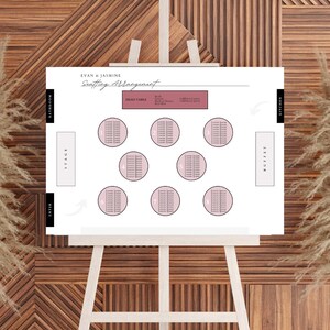 May include: A white wedding seating chart with the text "Evan & Jasmine Seating Arrangement" at the top. The chart includes a head table, 8 round tables, a stage, a buffet, a bathroom, and a kitchen.